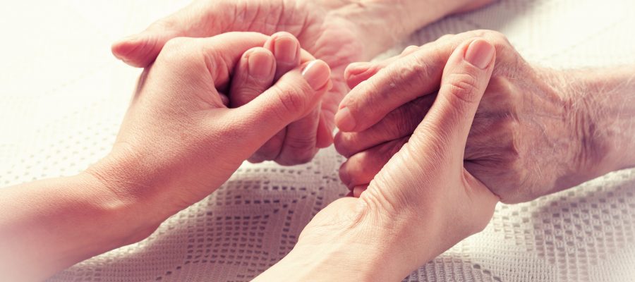 Senior man, woman with their caregiver at home. Concept of health care for elderly old people disabled. Elderly man.